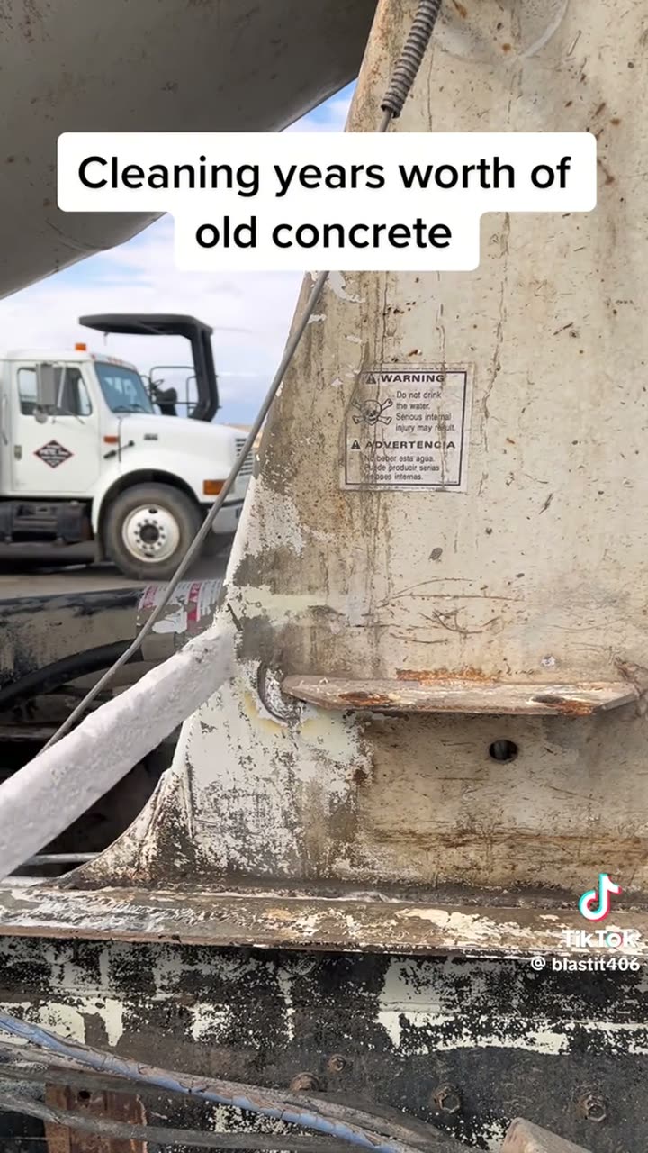 Hardened build-up coming off the frame under the nozzle. The part a still photograph cannot show: nothing is struck, scraped or dismantled.